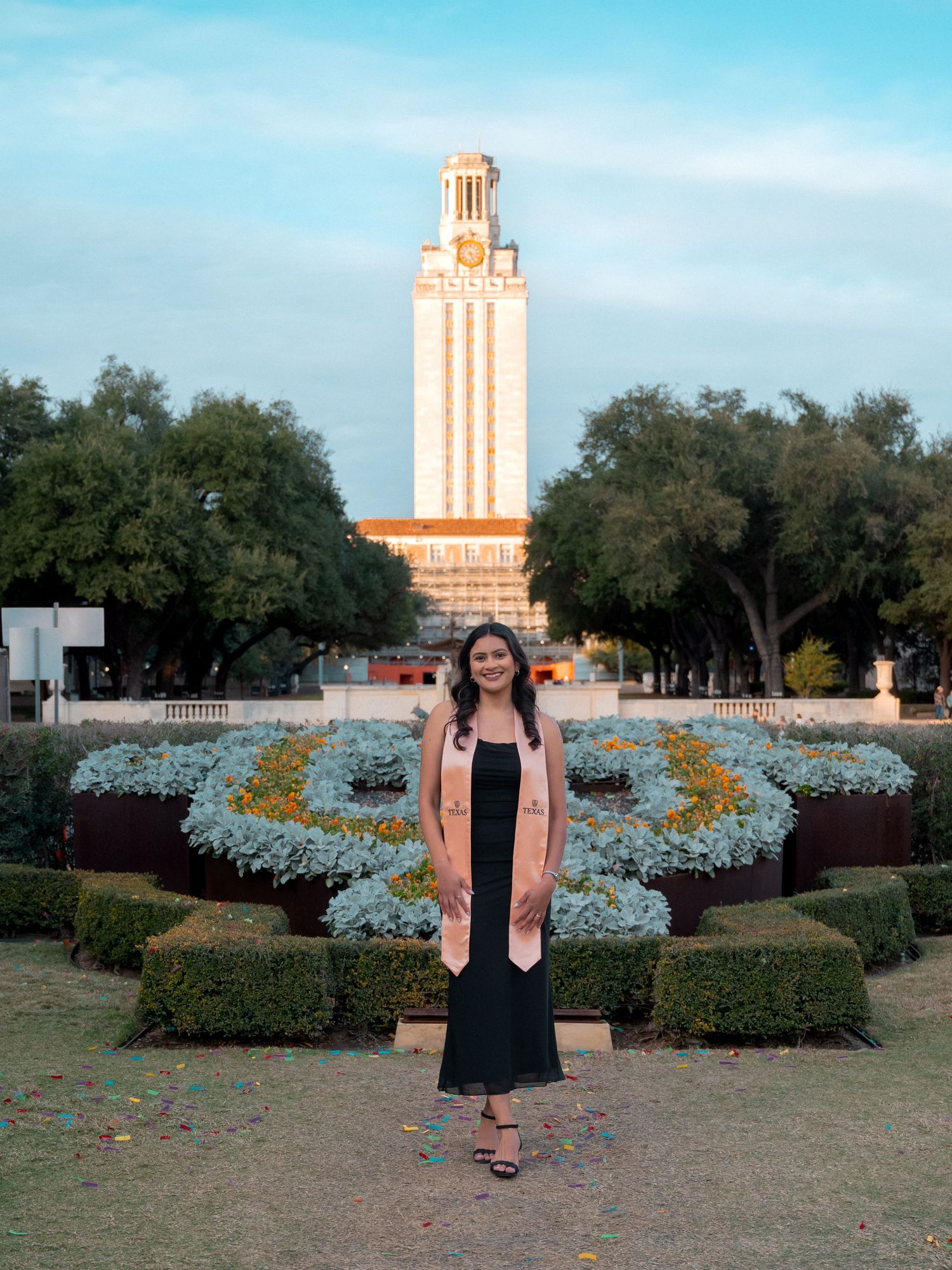 A series of graduation photos taken at the University of Texas Tower with bluebonnets in the foreground.