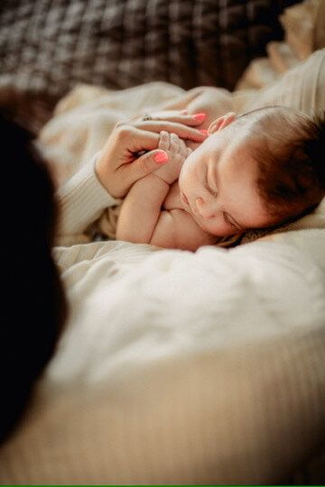 Indoor lifestyle family photography session with mother and newborn in Omaha, Nebraska