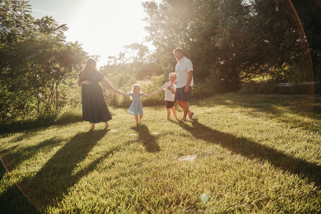 Outdoor family photography session with parents and children during golden hour in Omaha, Nebraska