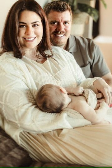 Indoor lifestyle family photography session with parents and newborn in Omaha, Nebraska