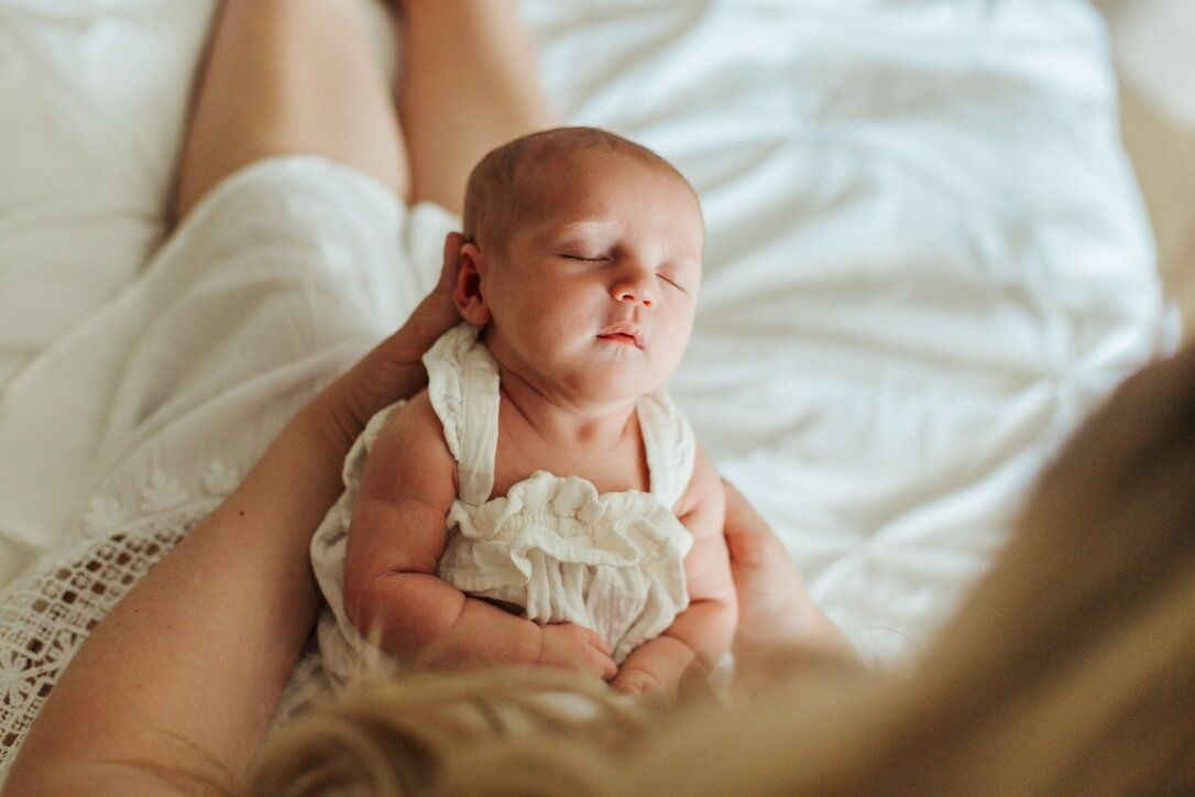 Indoor lifestyle family photography session with mother and newborn in Omaha, Nebraska