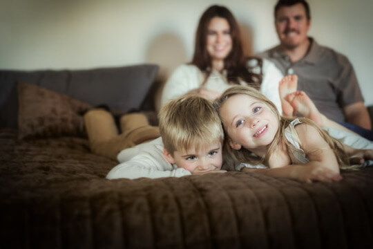 Indoor lifestyle family photography session with parents, siblings and newborn in Omaha, Nebraska
