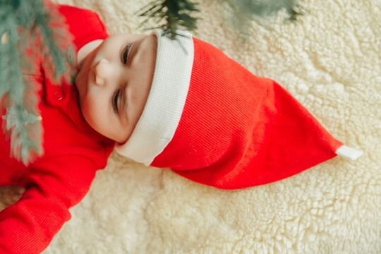 Christmas lifestyle family photography session with baby in Santa hat in Omaha, Nebraska