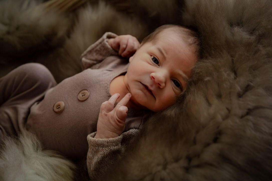 Baby boy in basket from newborn lifestyle photography session in Omaha, Nebraska