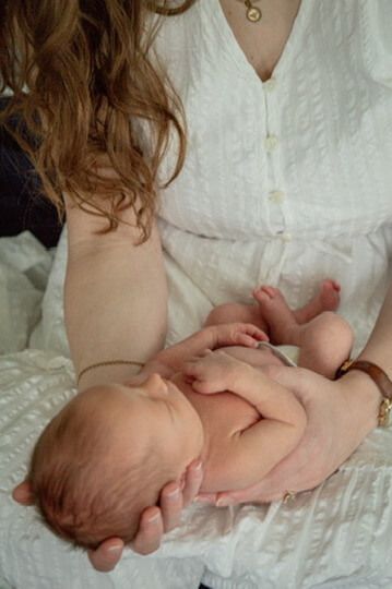 Indoor lifestyle family photography session with mother and newborn in Omaha, Nebraska
