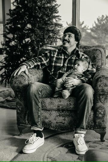 Indoor Christmas lifestyle family photography session with father and baby in Omaha, Nebraska
