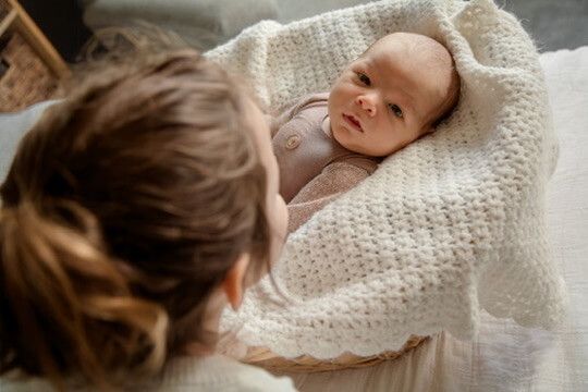 Indoor lifestyle family photography session with sister and newborn in Omaha, Nebraska