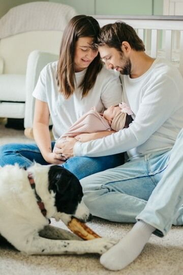Indoor lifestyle family photography session with parents and newborn in Omaha, Nebraska