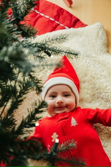 Christmas lifestyle family photography session with baby under tree in Omaha, Nebraska
