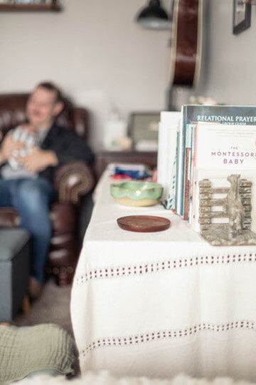 Indoor lifestyle family photography session with father and newborn in Omaha, Nebraska