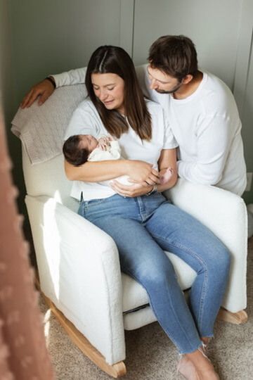 Indoor lifestyle family photography session with parents and newborn in Omaha, Nebraska