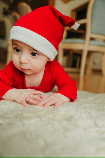Christmas lifestyle family photography session with baby in Santa hat in Omaha, Nebraska