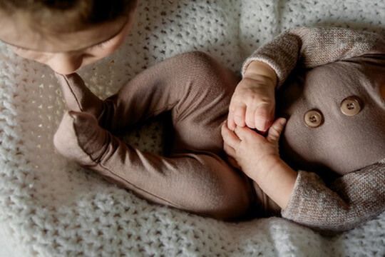 Indoor lifestyle family photography session with sibling and newborn in Omaha, Nebraska