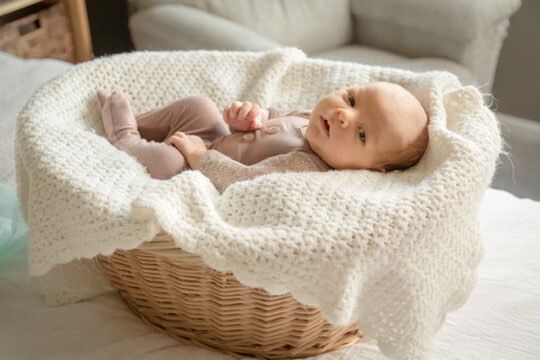 Baby boy in basket from newborn lifestyle photography session in Omaha, Nebraska