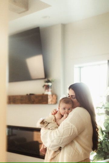 Indoor lifestyle family photography session with mother and newborn in Omaha, Nebraska