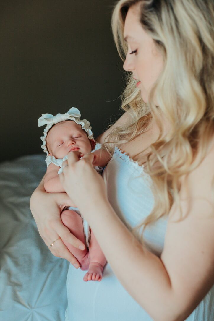 Indoor lifestyle family photography session with mother and newborn in Omaha, Nebraska