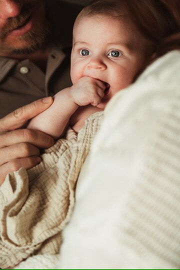 Indoor lifestyle family photography session with parents and baby in Omaha, Nebraska