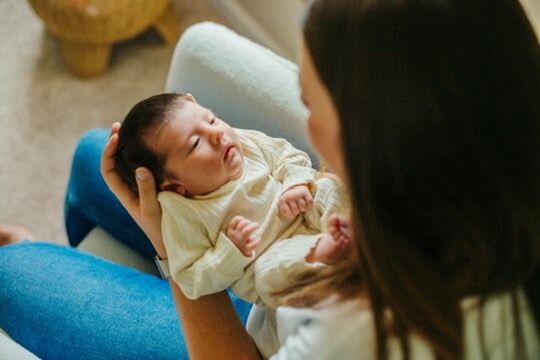Indoor lifestyle family photography session with mother and newborn in Omaha, Nebraska