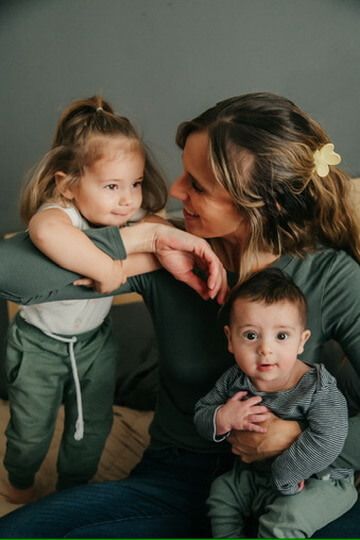Indoor lifestyle family photography session with mother, daughter and baby in Omaha, Nebraska