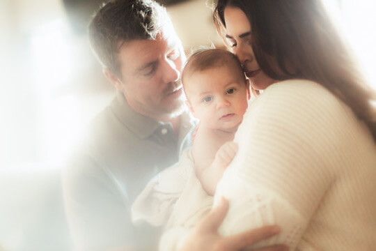 Indoor lifestyle family photography session with parents and baby in Omaha, Nebraska