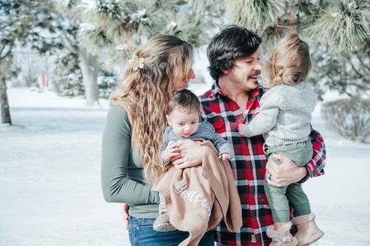Outdoor Christmas lifestyle family photography session with parents and children in Omaha, Nebraska
