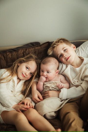 Indoor lifestyle family photography session with siblings and baby in Omaha, Nebraska