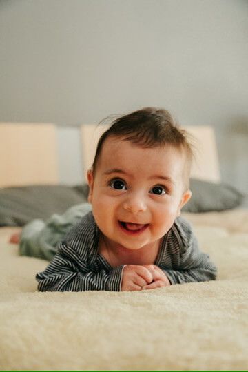 Baby boy smiling from family lifestyle photography session in Omaha, Nebraska