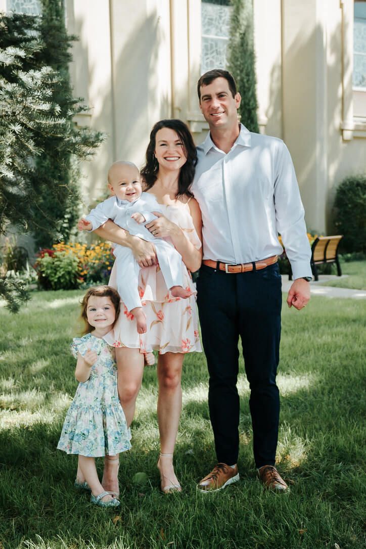 Outdoor family photography session with parents and children on baby's Catholic baptism day in Omaha, Nebraska