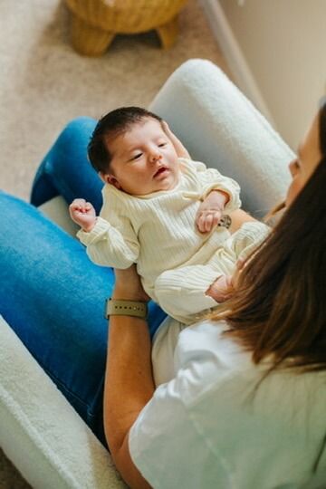 Indoor lifestyle family photography session with mother and newborn in Omaha, Nebraska