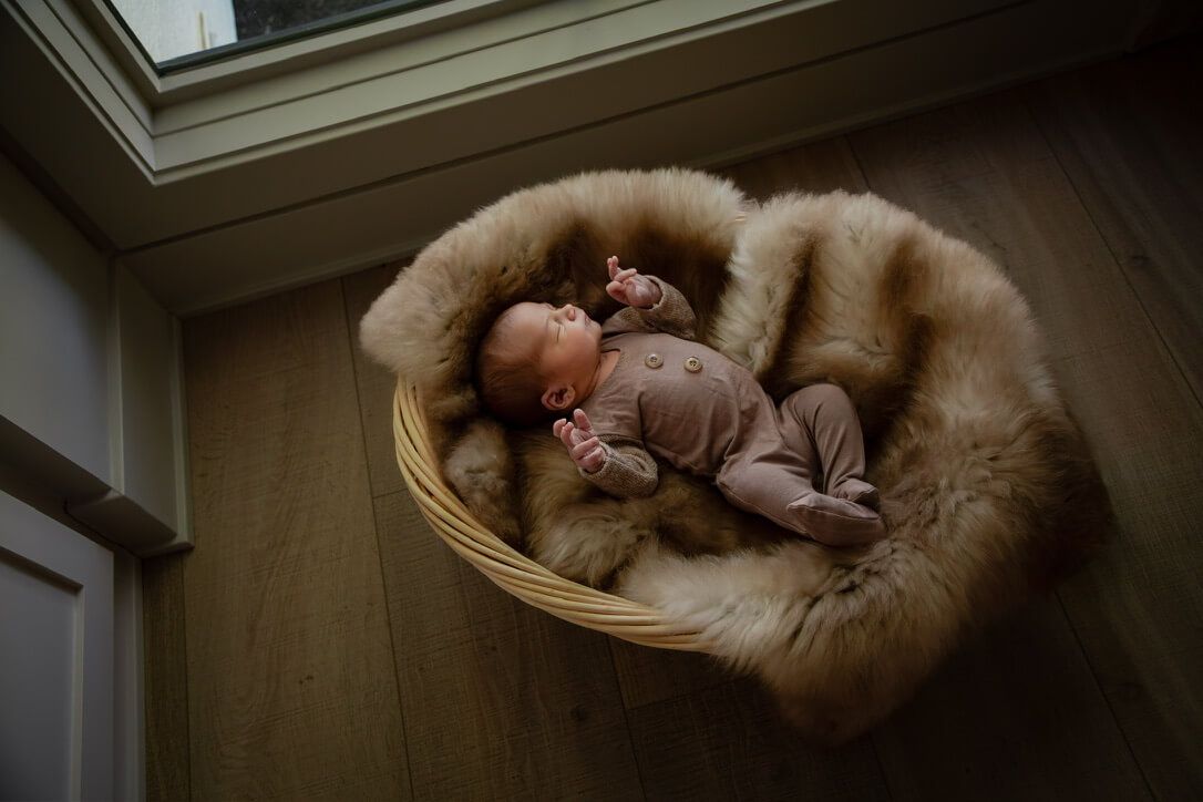 Baby boy in basket from newborn lifestyle photography session in Omaha, Nebraska