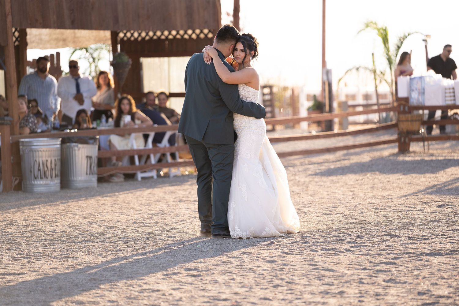 Wedding celebration at rustic outdoor venue with stone pathway.