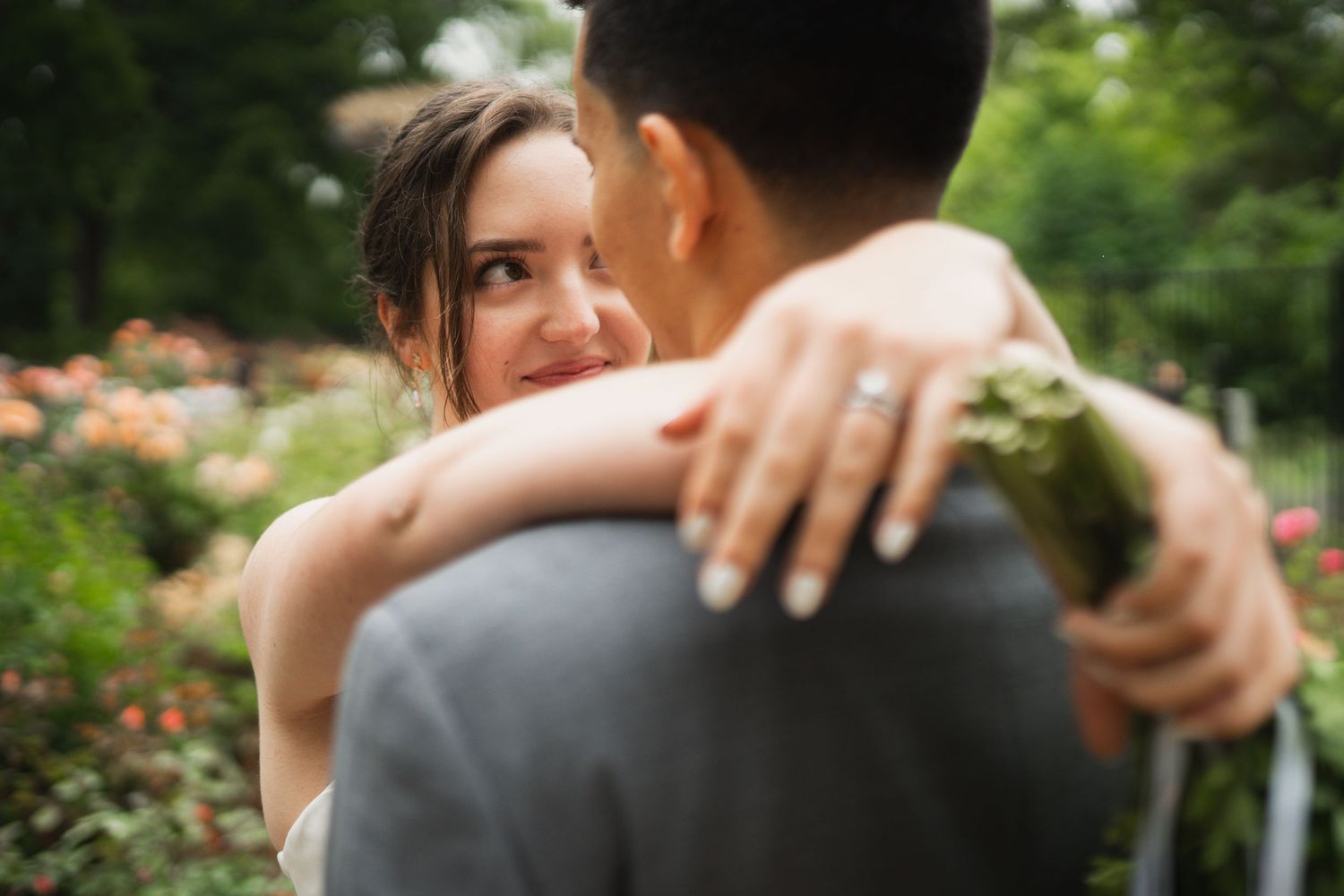 Intimate wedding moment captured in a lush garden setting.