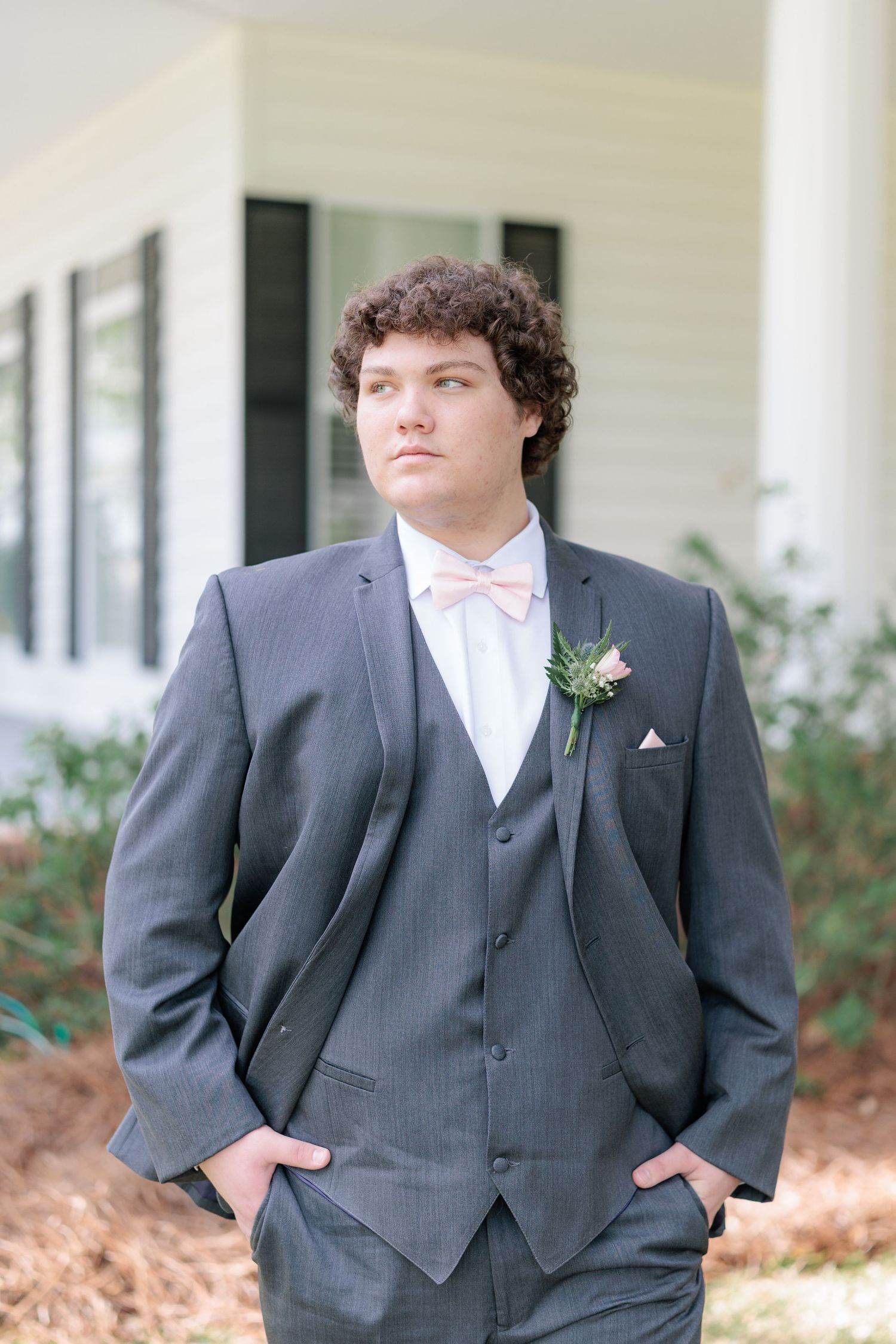 Sharp portrait of a high school guy dressed in a classic prom attire with a boutonniere, taken by a photographer based in Valdosta, GA.
