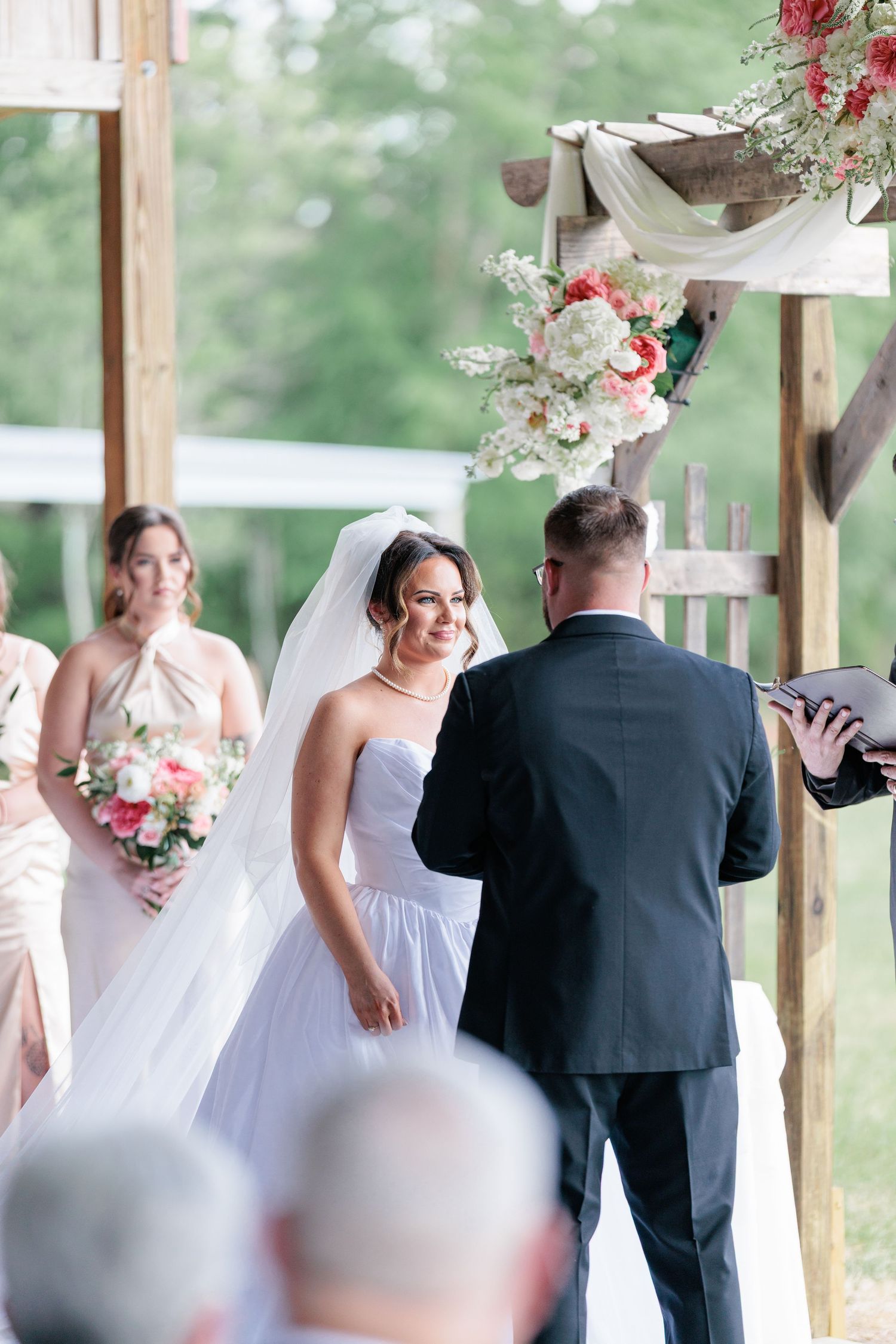 Portrait of a bride and groom embracing during the ceremony during their wedding day in South Georgia.