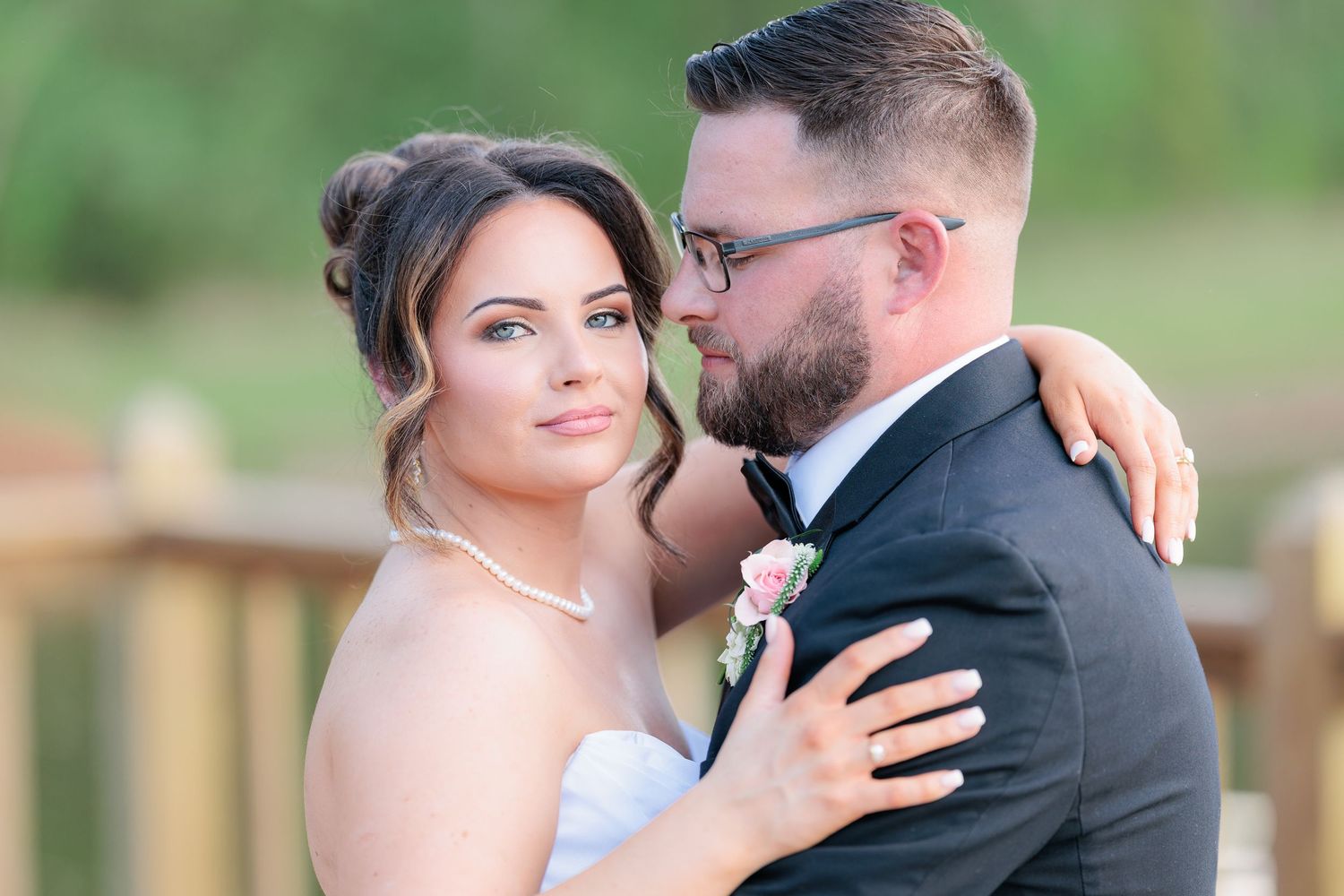 Candid portrait of a bride and groom embracing during a romantic sunset session by a wedding photographer in South Georgia.