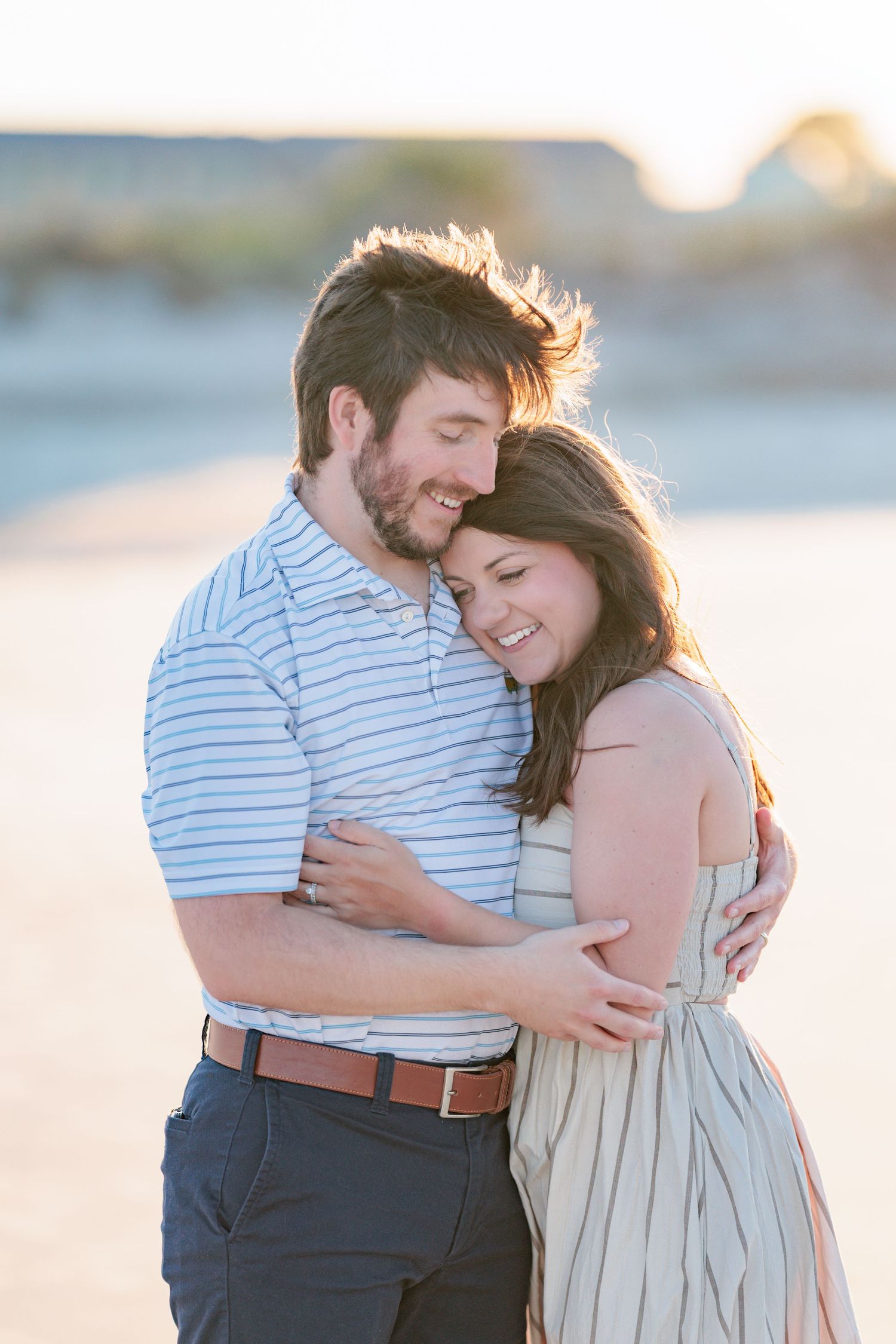 Authentic, joyful engagement portrait of a couple laughing together during a golden hour session with photographer based in Valdosta, GA.