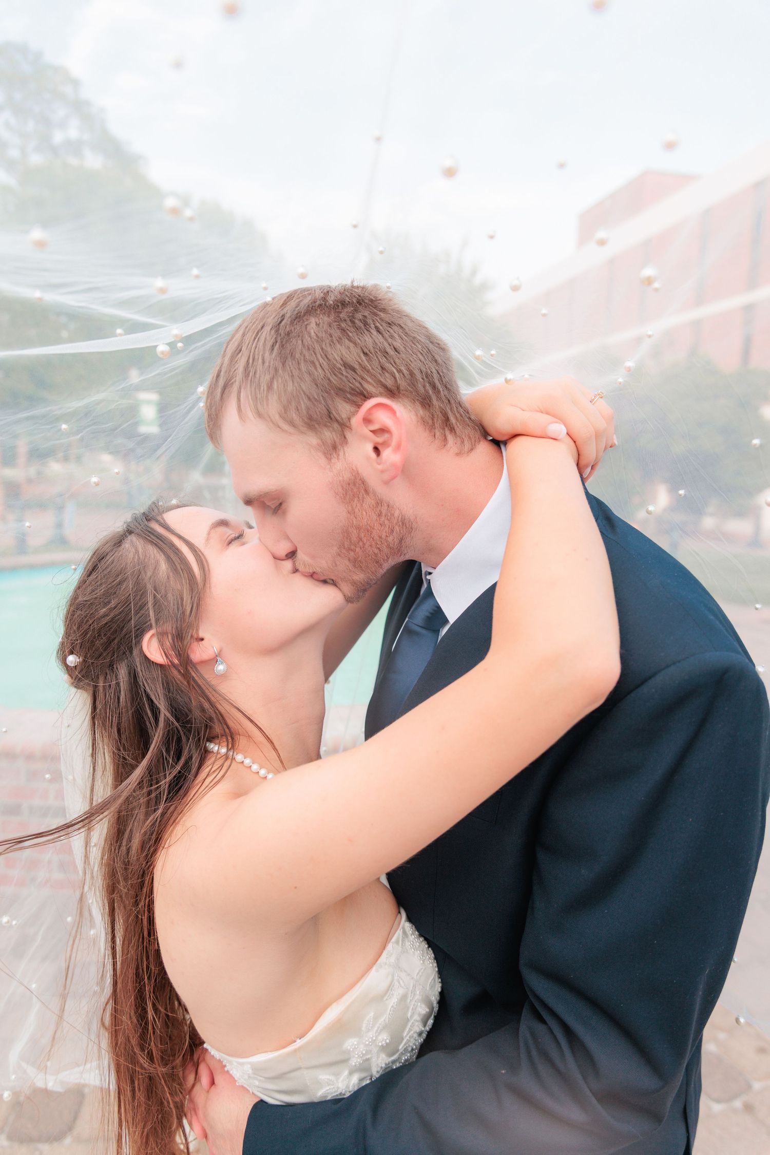 Portrait of a bride and groom embracing during a romantic couple's portrait session during their wedding day in South Georgia.