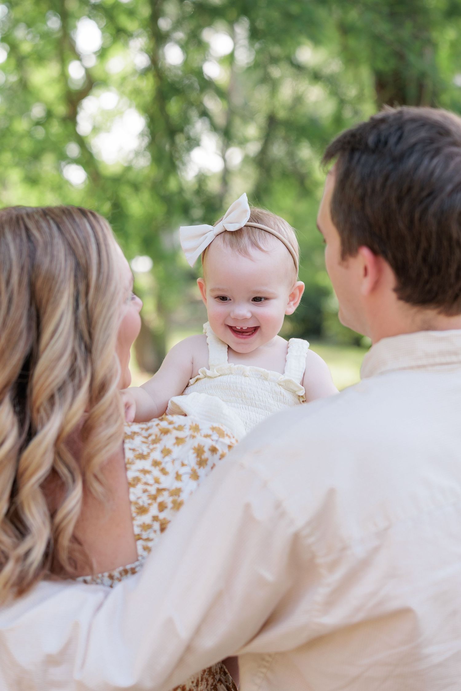 Candid, natural family portrait session featuring parents and children laughing together outdoors in South Georgia.
