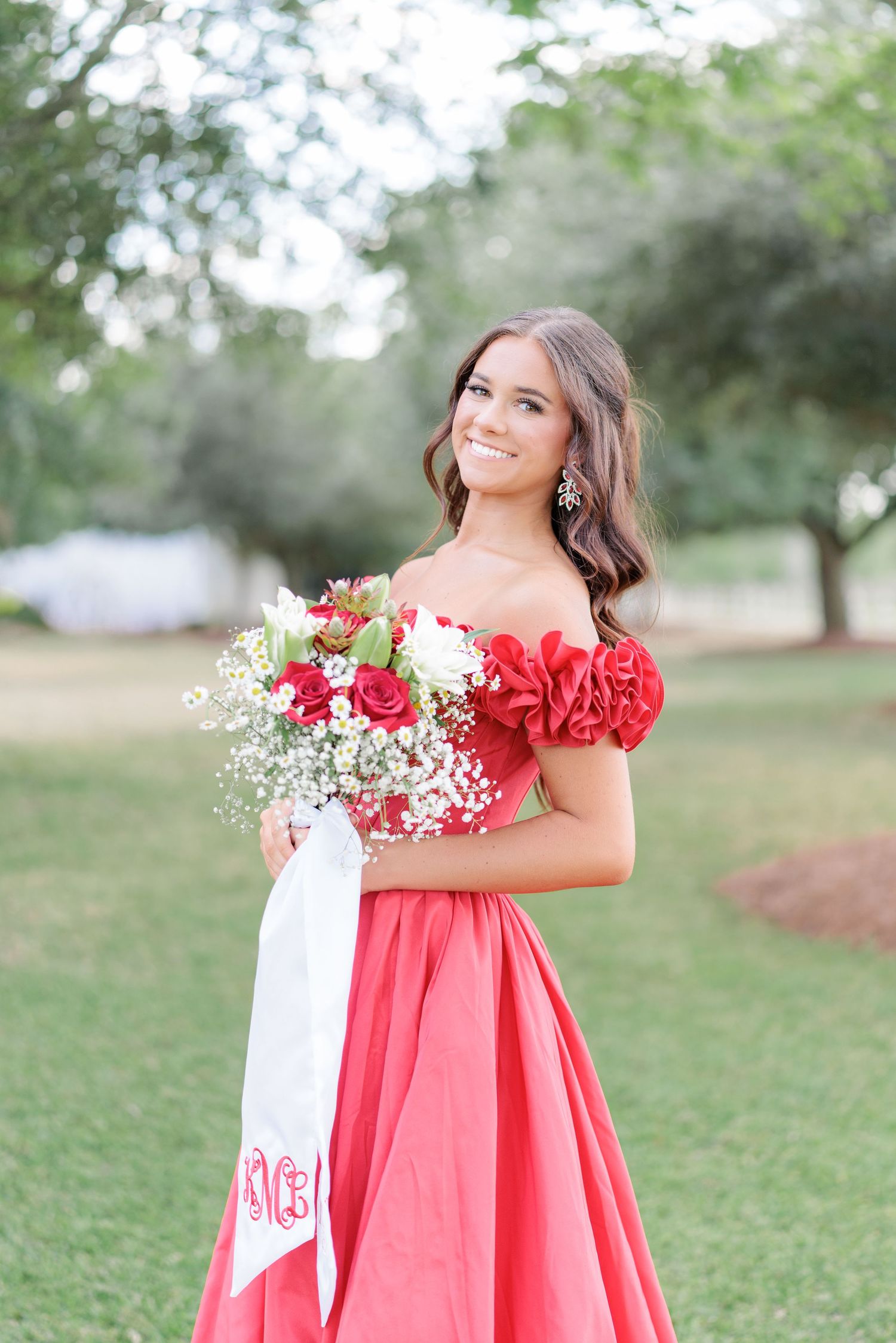 Beautiful portrait of a high school girl in her elegant prom dress holding a floral arrangement, taken by a photographer in Valdosta, GA.