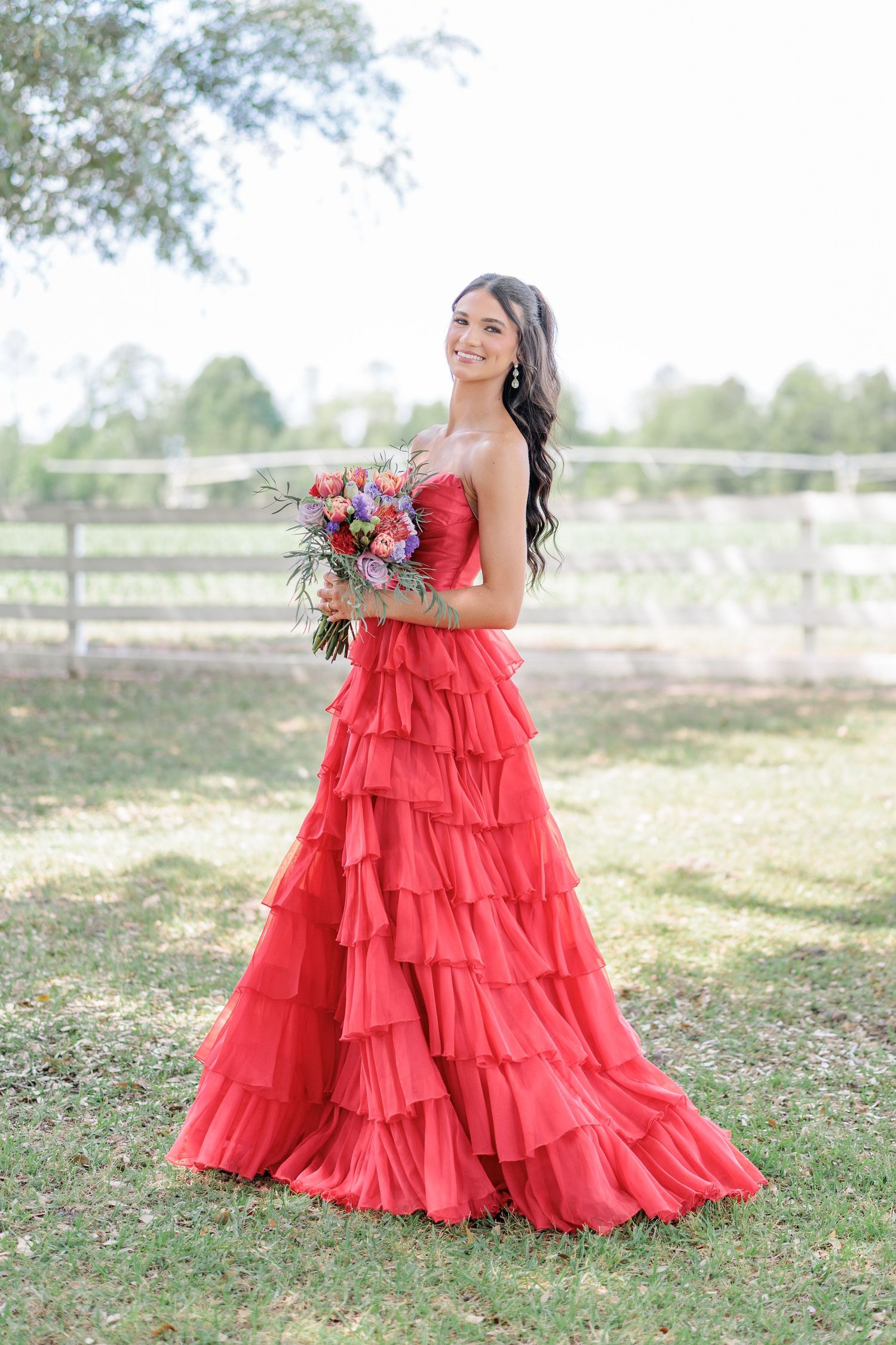 Beautiful portrait of a high school girl in her elegant prom dress holding a floral arrangement, taken by a photographer in Valdosta, GA.