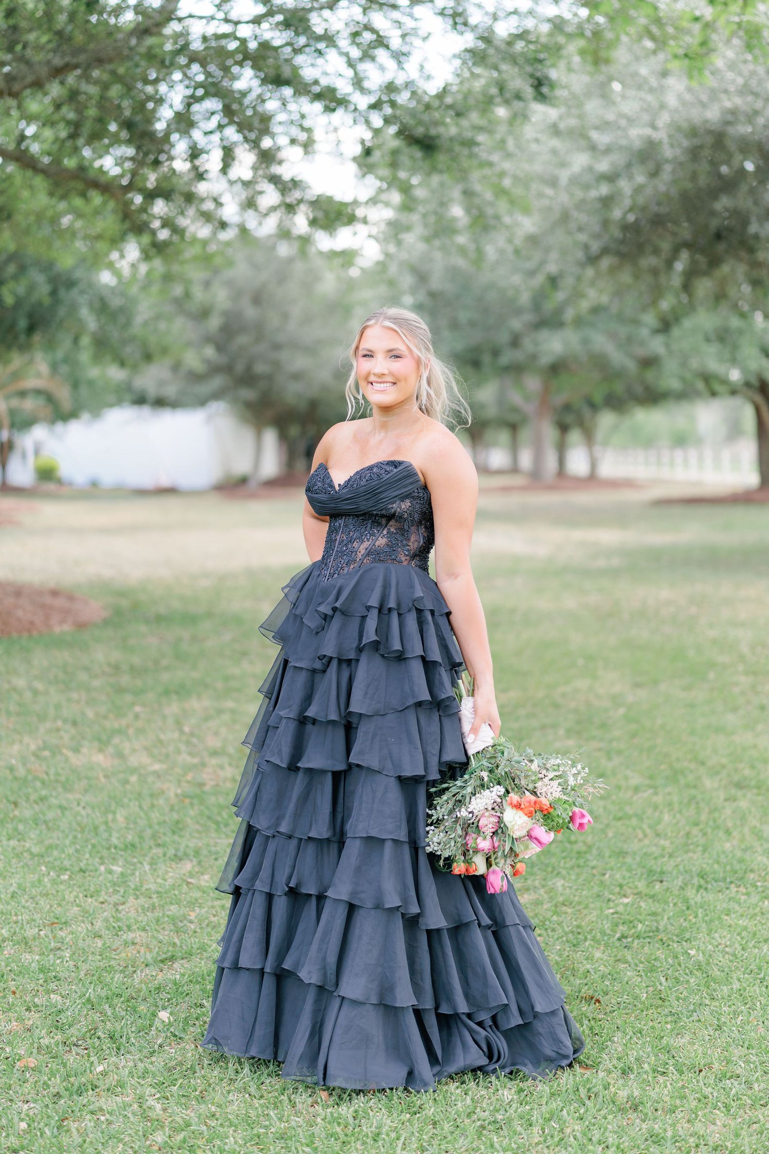 Beautiful portrait of a high school girl in her elegant prom dress holding a floral arrangement, taken by a photographer in Valdosta, GA.
