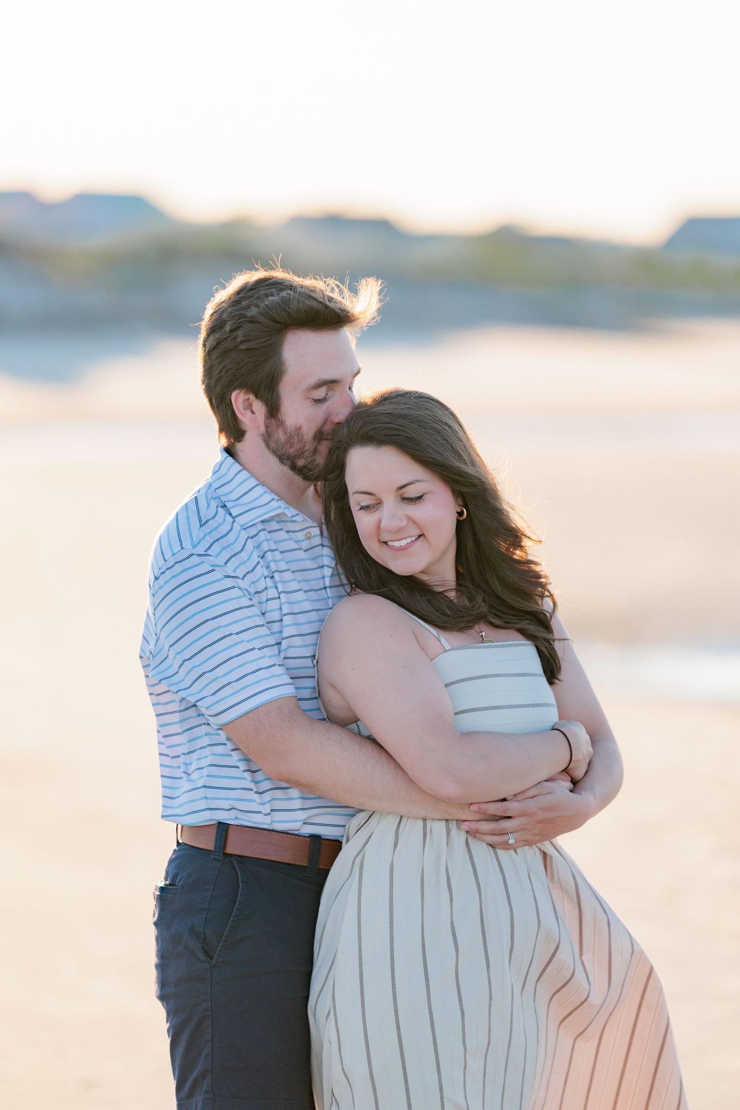 Authentic, joyful engagement portrait of a couple laughing together during a golden hour session in Valdosta, GA.