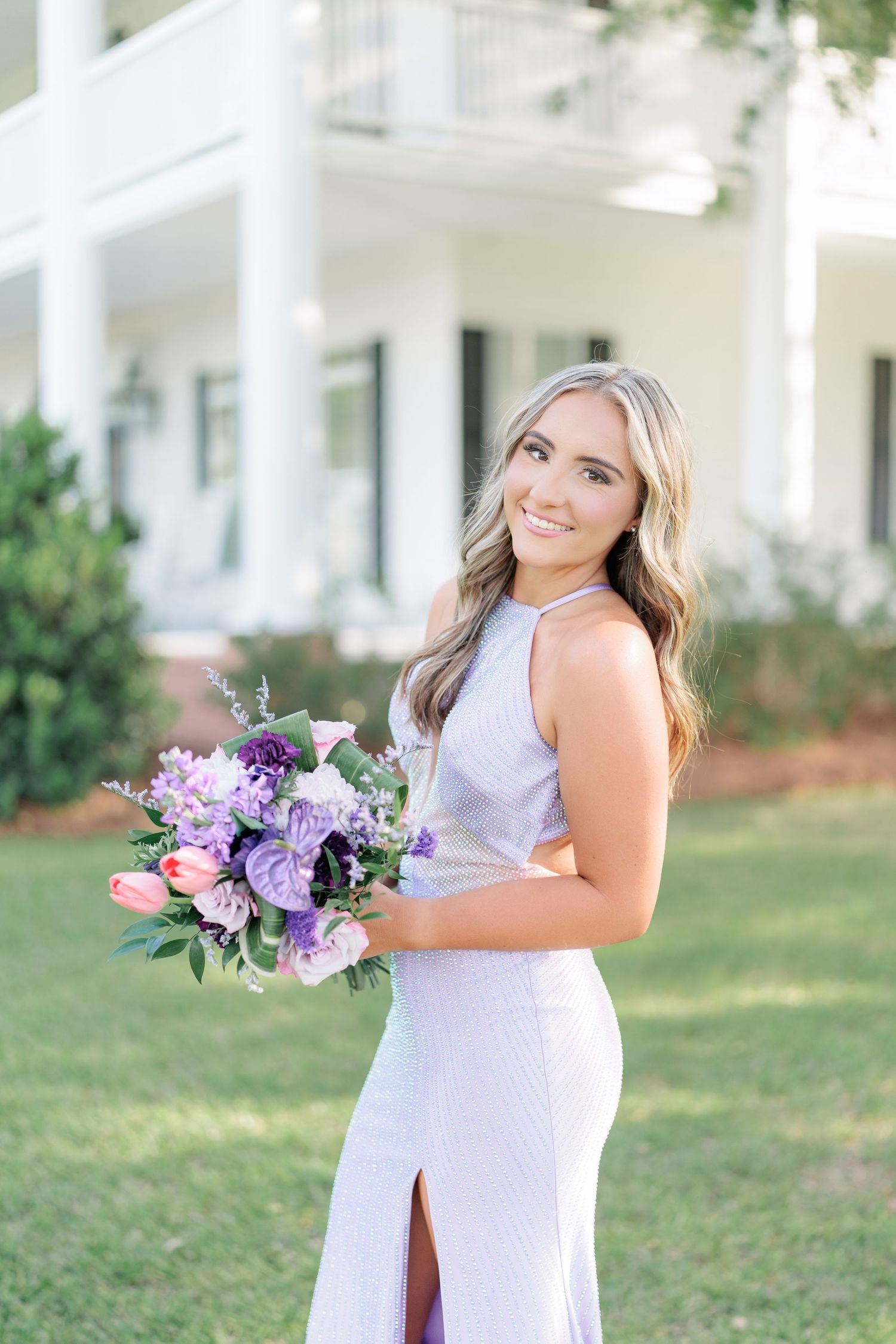 Beautiful portrait of a high school girl in her elegant prom dress holding a floral arrangement, taken by a photographer in Valdosta, GA.