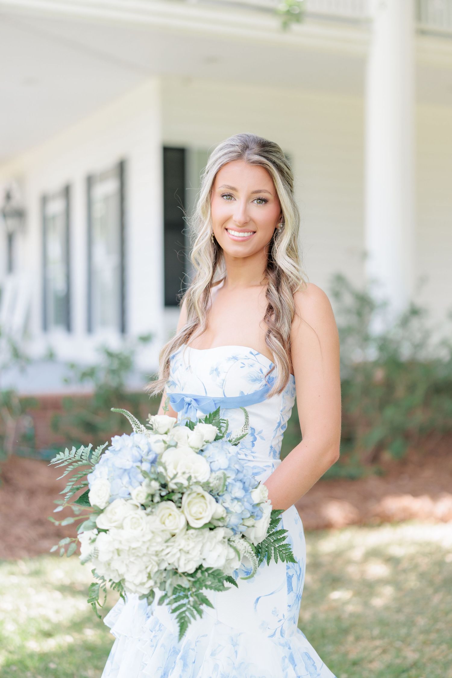 Beautiful portrait of a high school girl in her elegant prom dress holding a floral arrangement, taken by a photographer in Valdosta, GA.