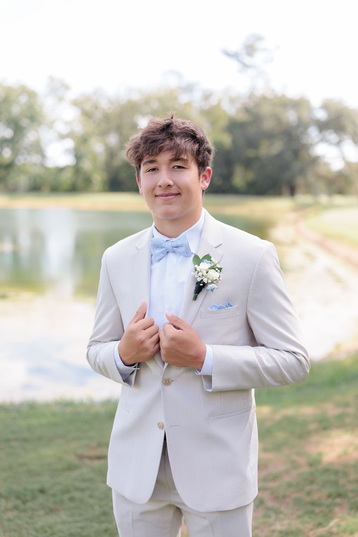 Sharp portrait of a high school guy dressed in a classic prom attire with a boutonniere, taken by a photographer based in Valdosta, GA.