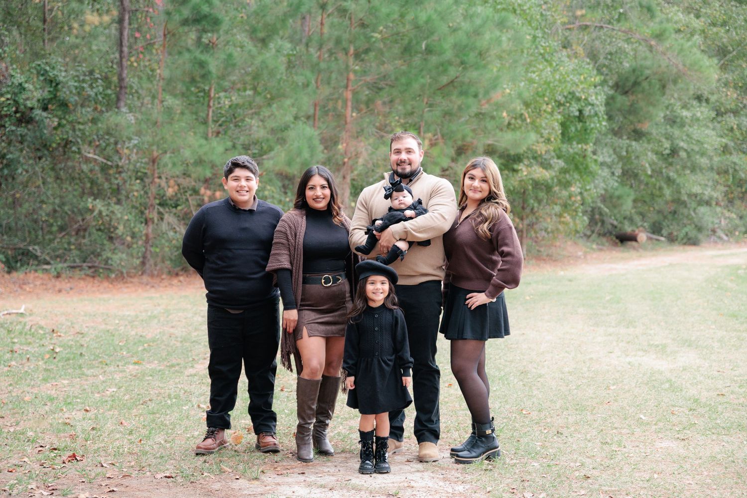 Candid, natural family portrait session featuring parents and children laughing together outdoors in South Georgia.