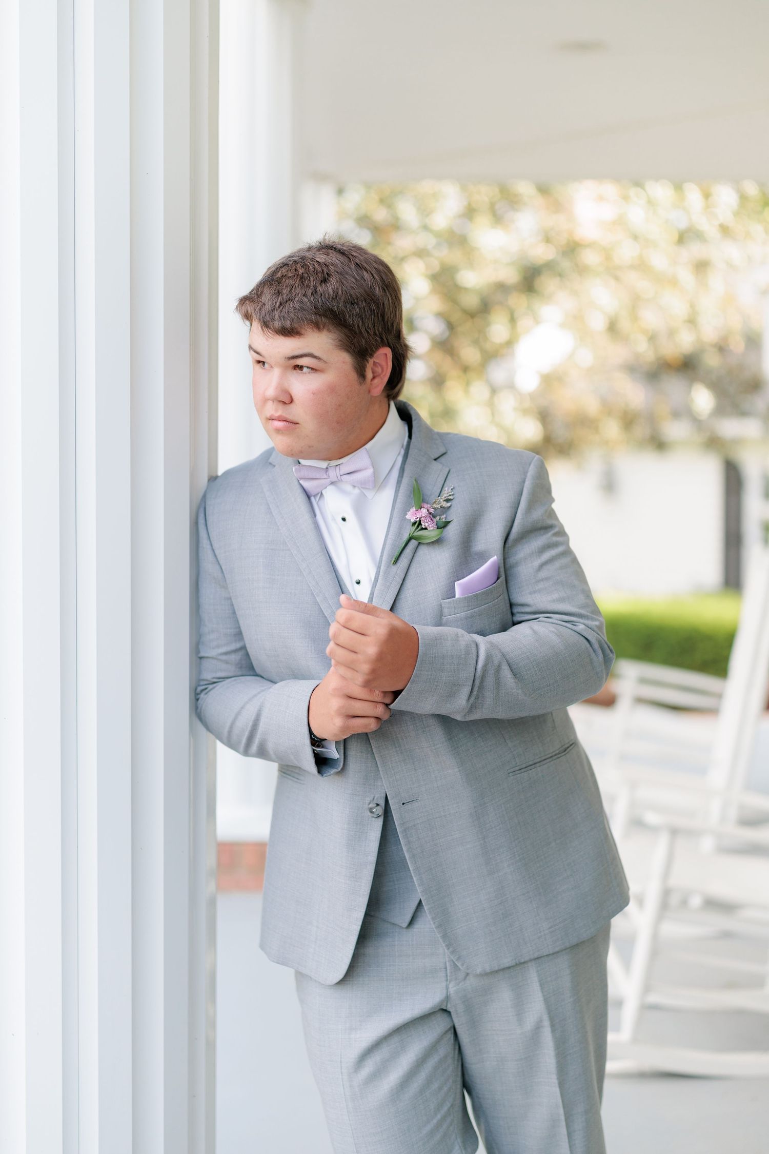 Sharp portrait of a high school guy dressed in a classic prom attire with a boutonniere, taken by a photographer based in Valdosta, GA.