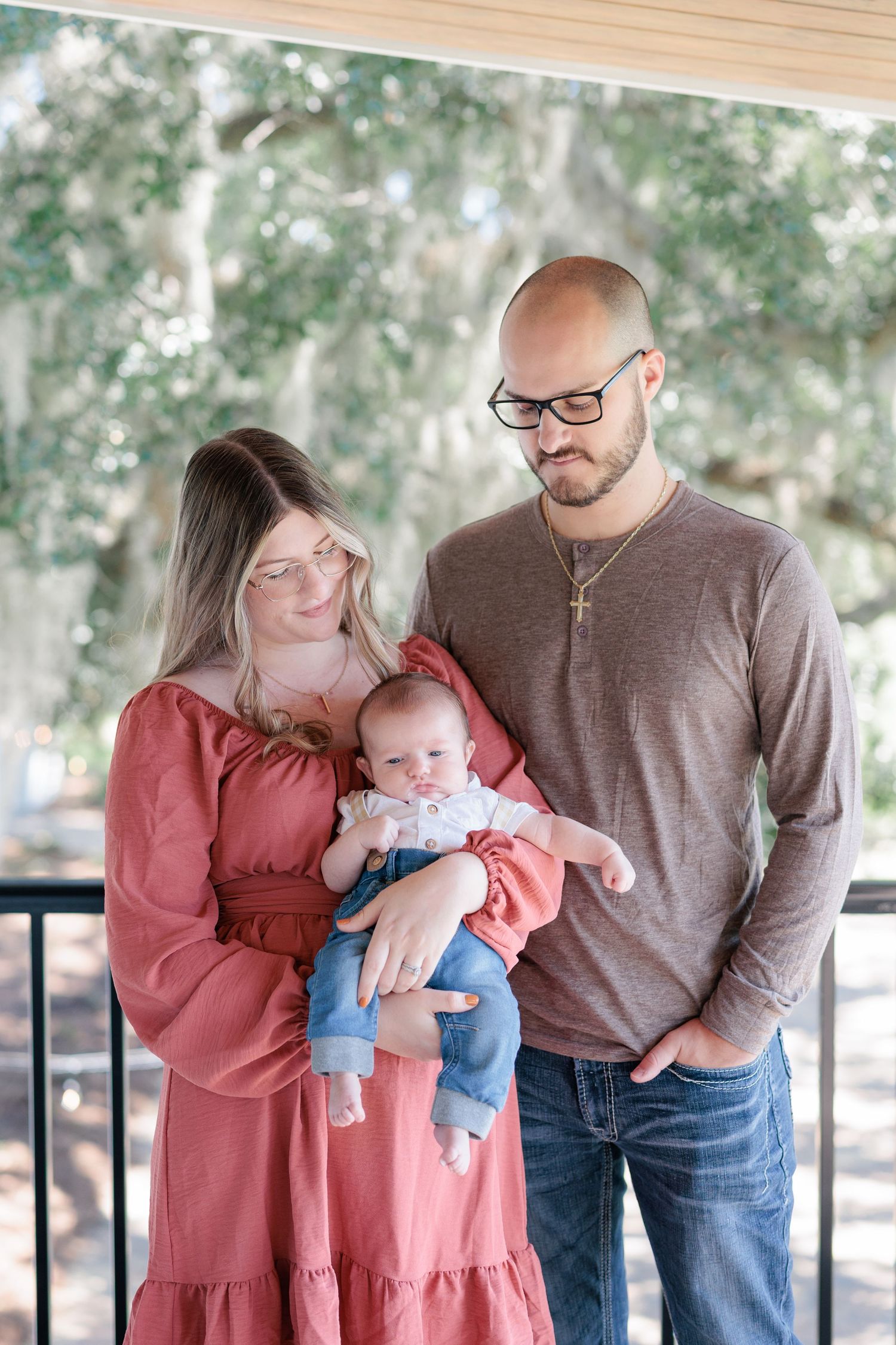 Candid, natural family portrait session featuring parents and children laughing together outdoors in South Georgia.