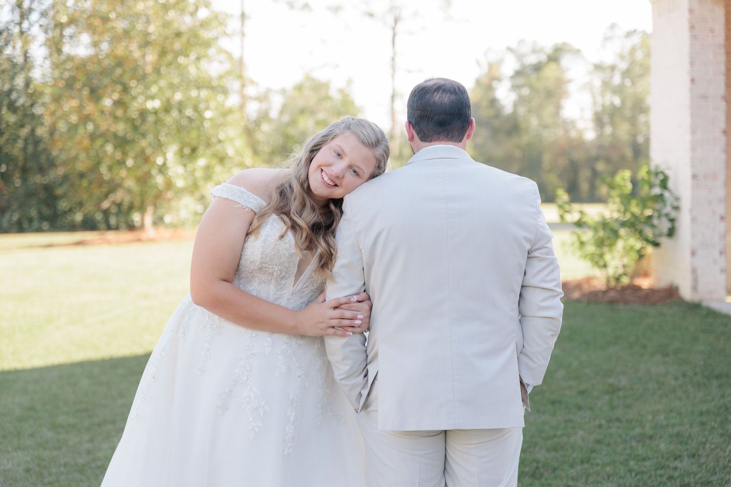 Candid portrait of a bride and groom embracing during a romantic couple's portrait session during their wedding day in South Georgia.
