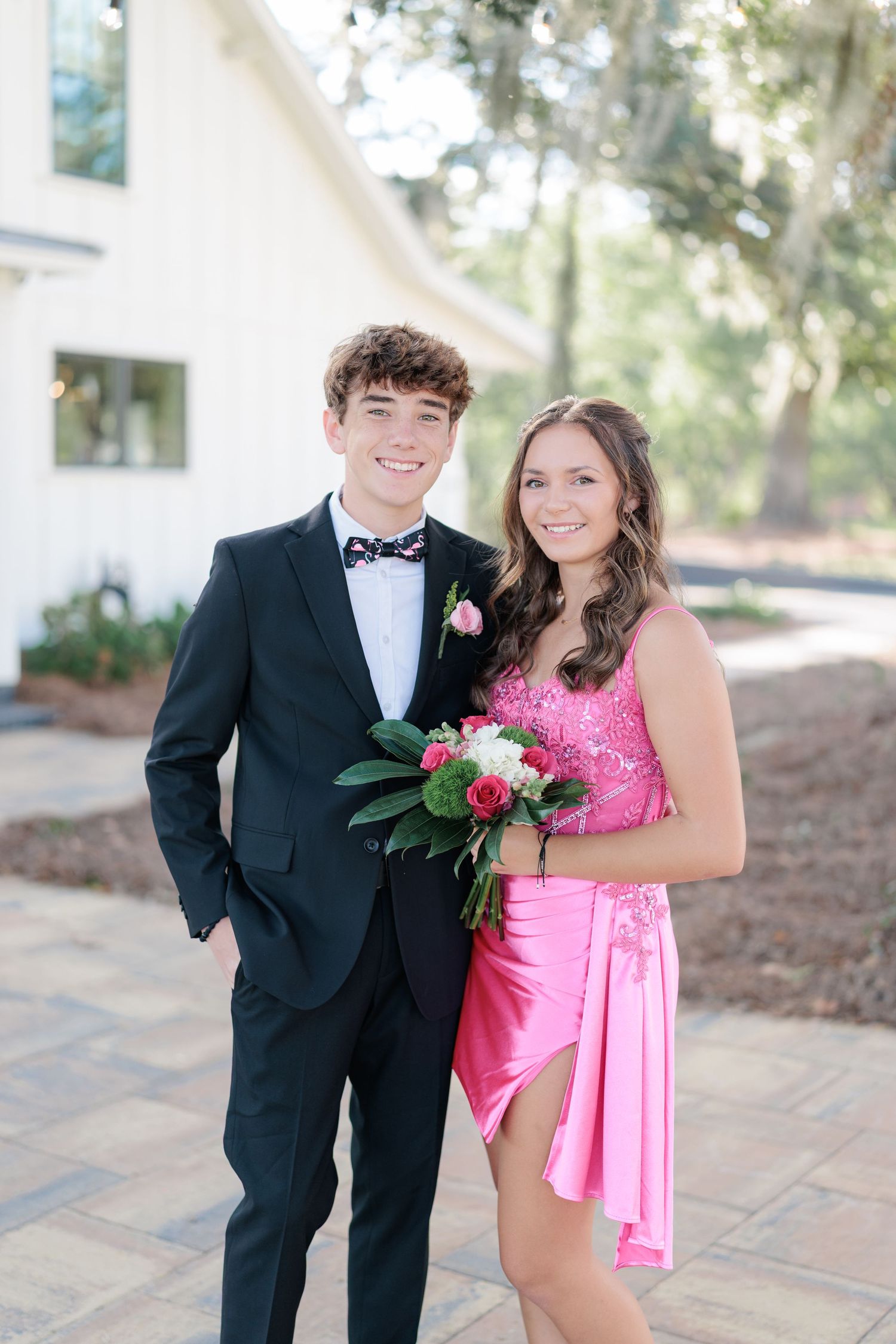 Elegant prom couple portrait of high school students dressed up in formalwear before the dance in Valdosta, Georgia.